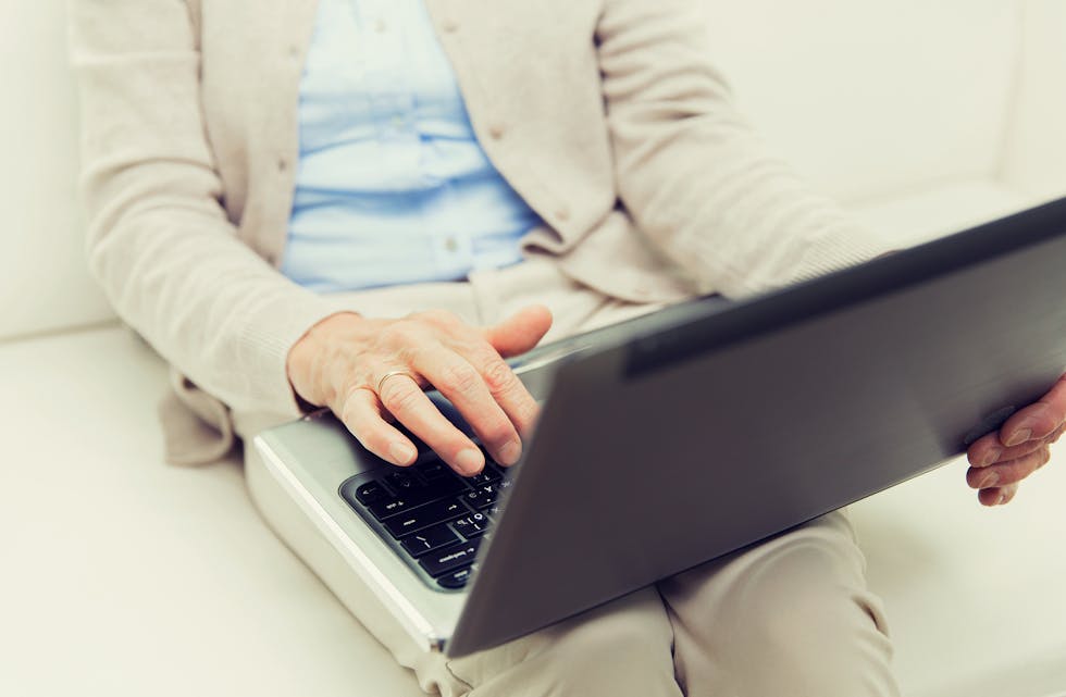 close up of senior woman with laptop at home