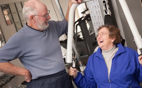 Senior Adult Couple Working Out in the Gym.