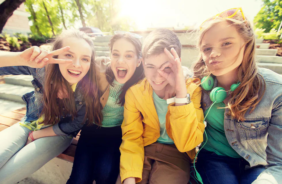 happy teenage students or friends having fun